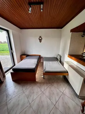 a bedroom with two beds in a room with a window at White House in Ternat