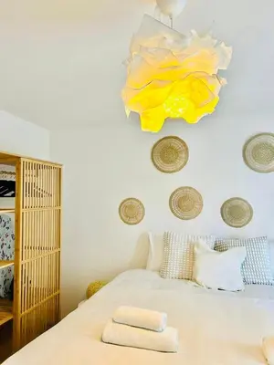 a bedroom with a bed and a chandelier at Appart Brussels EXPO & ATOMIUM in Grimbergen