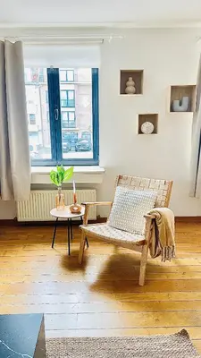 a room with a chair and a table and a window at Appart Brussels EXPO & ATOMIUM in Grimbergen
