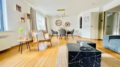 a living room with a couch and a table at Appart Brussels EXPO & ATOMIUM in Grimbergen