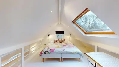 a bedroom with a bed in a attic at The Tile House - 2 bedroom property just south of Brussels in Sint-Genesius-Rode