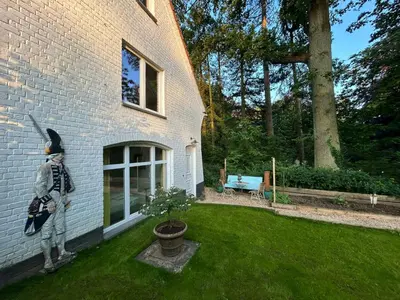 a statue of a man standing outside of a house at The Tile House - 2 bedroom property just south of Brussels in Sint-Genesius-Rode