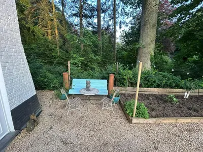 a blue table and chairs in a yard at The Tile House - 2 bedroom property just south of Brussels in Sint-Genesius-Rode