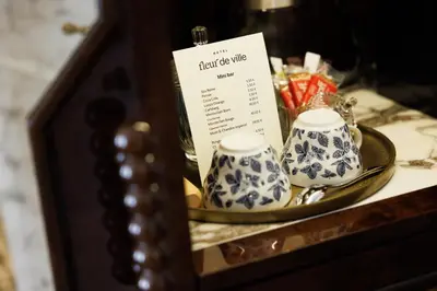 a table with two tea cups on a plate at Hotel Fleur de Ville in Brussels