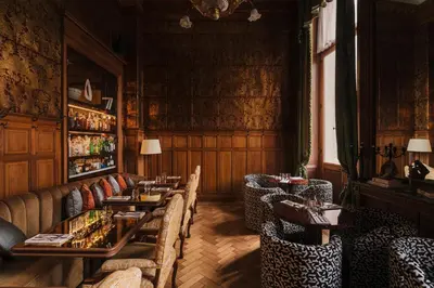 a restaurant with tables and chairs in a room at Hotel Fleur de Ville in Brussels