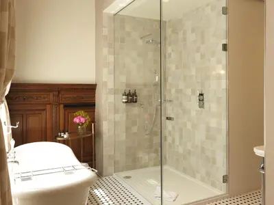 a bathroom with a toilet and a glass shower at Hotel Fleur de Ville in Brussels