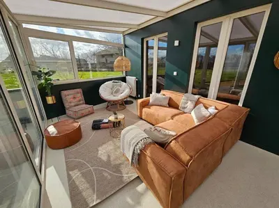 a living room with a couch and a chair at BNB Green refuge: Vakantiehuis met zeer grote tuin in Londerzeel