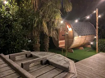 a hobbit house with a wooden table and a wooden deck at BNB Green refuge: Vakantiehuis met zeer grote tuin in Londerzeel