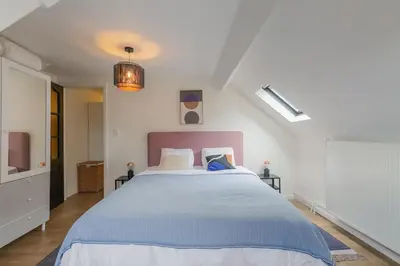 a bedroom with a large bed in a room at Cosy duplex nearby city centre of Ghent for 6 in Ghent