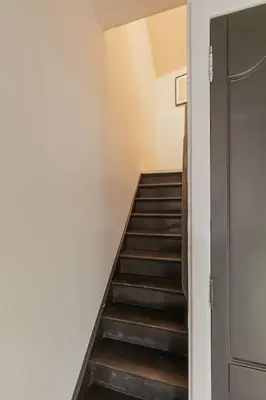 a hallway with a staircase leading up to a room at Cosy duplex nearby city centre of Ghent for 6 in Ghent