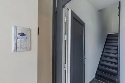 a hallway with a door and a stair case at Cosy duplex nearby city centre of Ghent for 6 in Ghent