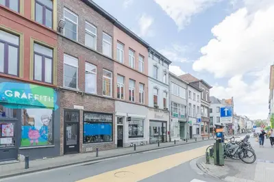 a city street with buildings and people walking down the street at Cosy duplex nearby city centre of Ghent for 6 in Ghent