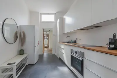 a kitchen with a white refrigerator and a sink at Ruime studio in centrum voor 4 in Ghent