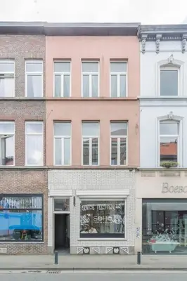 a large brick building with windows on a city street at Ruime studio in centrum voor 4 in Ghent