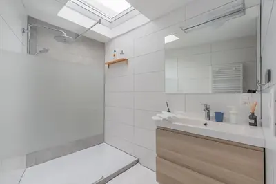 a white bathroom with a sink and a shower at Ruime studio in centrum voor 4 in Ghent