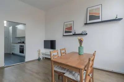 a kitchen and dining room with a table and chairs at Ruime studio in centrum voor 4 in Ghent