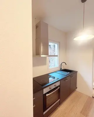 a kitchen with a sink and a counter top at Sān home’s in Antwerp