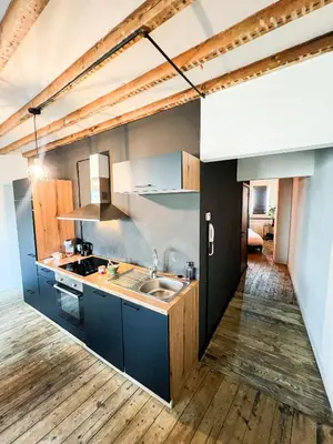 a kitchen with blue cabinets and a sink at Sān home’s in Antwerp