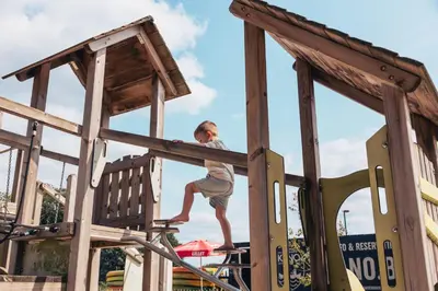 a young boy riding a skateboard in a playground at KARIBU - Olifant in Kasterlee