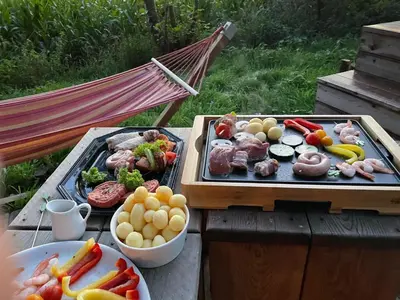 a picnic table with two trays of food and vegetables at KARIBU - Olifant in Kasterlee