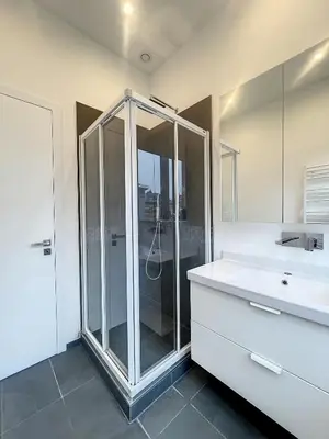 a bathroom with a shower and a sink at Elegant Flat Cinquantenaire in Brussels