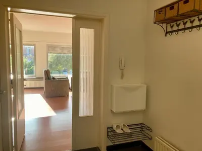 a hallway with a door leading to a living room at Charming Sunny 100m2 Entire Apartment with 2 bedrooms in Brasschaat