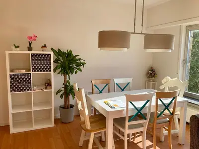a dining room with a white table and chairs at Charming Sunny 100m2 Entire Apartment with 2 bedrooms in Brasschaat