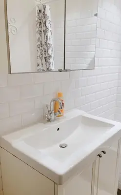 a white sink in a bathroom with a mirror at Charming Sunny 100m2 Entire Apartment with 2 bedrooms in Brasschaat