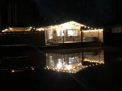 a house lit up at night with lights on it at The Zen Nest in Geel