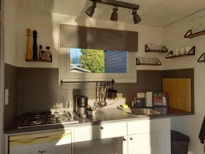 a kitchen with a sink and a stove and a window at The Zen Nest in Geel