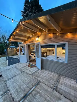 a house with a patio with awning on it at The Zen Nest in Geel