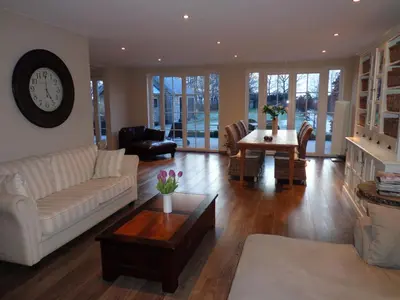 a living room with a couch and a table at B&B Fragaria in Hoogstraten