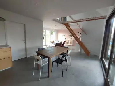 a dining room with a wooden table and chairs at Huis Belijn in Lokeren