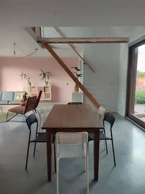 a dining room with a wooden table and chairs at Huis Belijn in Lokeren