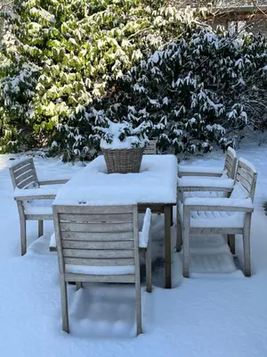 a table and chairs covered in snow at Kokoon in 't groen in Leuven