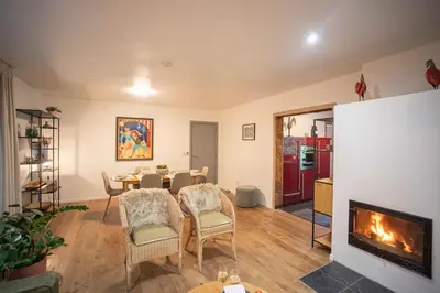 a living room with a table and a fireplace at Kokoon in 't groen in Leuven