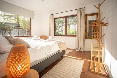 a bedroom with a bed and a ladder and a mirror at Kokoon in 't groen in Leuven