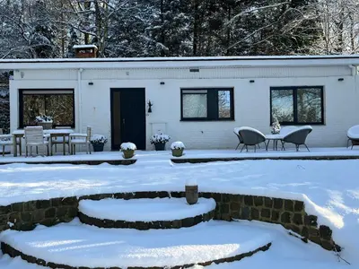 a house covered in snow with a patio at Kokoon in 't groen in Leuven