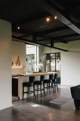 a kitchen with a table and chairs in a room at Schuur 80 in Haasdonk