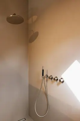 a shower in the corner of a bathroom at Schuur 80 in Haasdonk