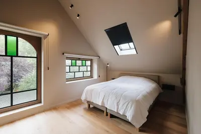 a bedroom with a bed and a flat screen tv at Schuur 80 in Haasdonk