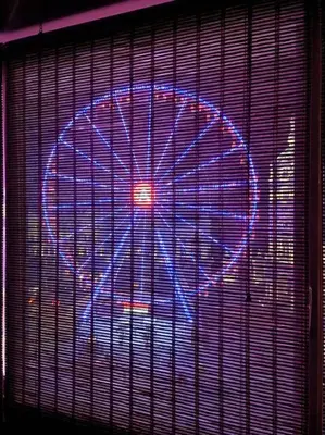 a lit up ferris wheel in a window at Stunning View + Japan Design Bed @ Central Station in Antwerp