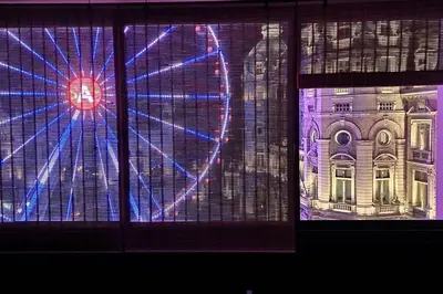 a window with a view of a building at night at Stunning View + Japan Design Bed @ Central Station in Antwerp