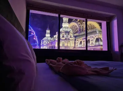 a bed in a room with a view of a building at Stunning View + Japan Design Bed @ Central Station in Antwerp