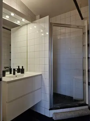 a bathroom with a shower and a sink at Stunning View + Japan Design Bed @ Central Station in Antwerp