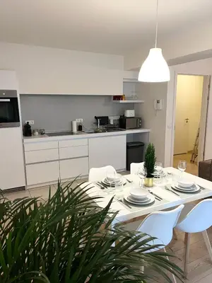 a kitchen and dining room with a table and chairs at Elegant flat - Center of Brussels in Brussels