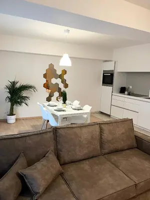 a living room with a couch and a table at Elegant flat - Center of Brussels in Brussels