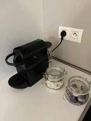 a black bag sitting on top of a counter next to a jar at Elegant flat - Center of Brussels in Brussels