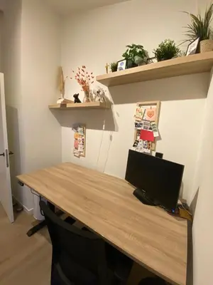 a desk with a computer on top of it at Luxury & cozy apartment in Lubbeek