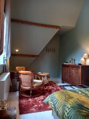 a bedroom with a bed and a table and a chair at Dilectus (Via Caput) in Lokeren
